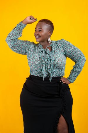 Lady in skirt and floral blouse displaying body positivity