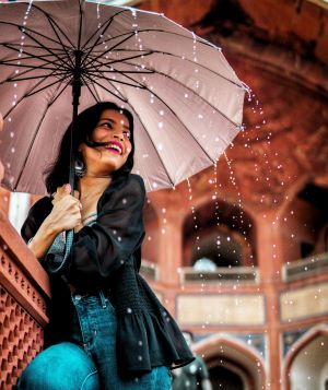 Rainy day fashion lady looking chic in fancy  umbrella