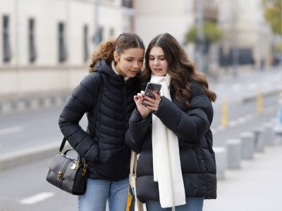 Ladies wear winter coats and white scarf