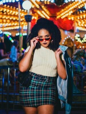 Lady wearing slaying in shades and a scotch skirt