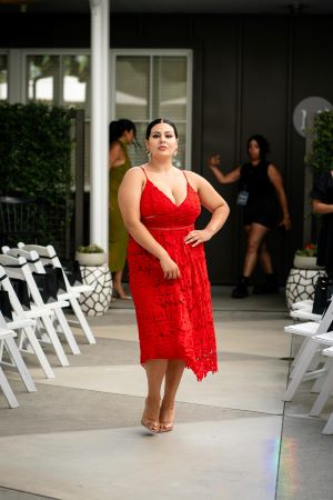 Lady nicely dressed up in a red dress for an event.