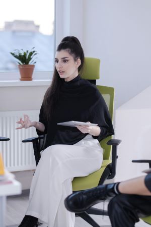 Lady looking elegant in black top and white trousers.